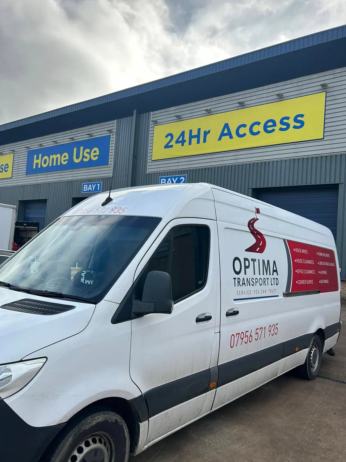 Optima Transport van parked outside commercial storage units ready for a commercial clearance