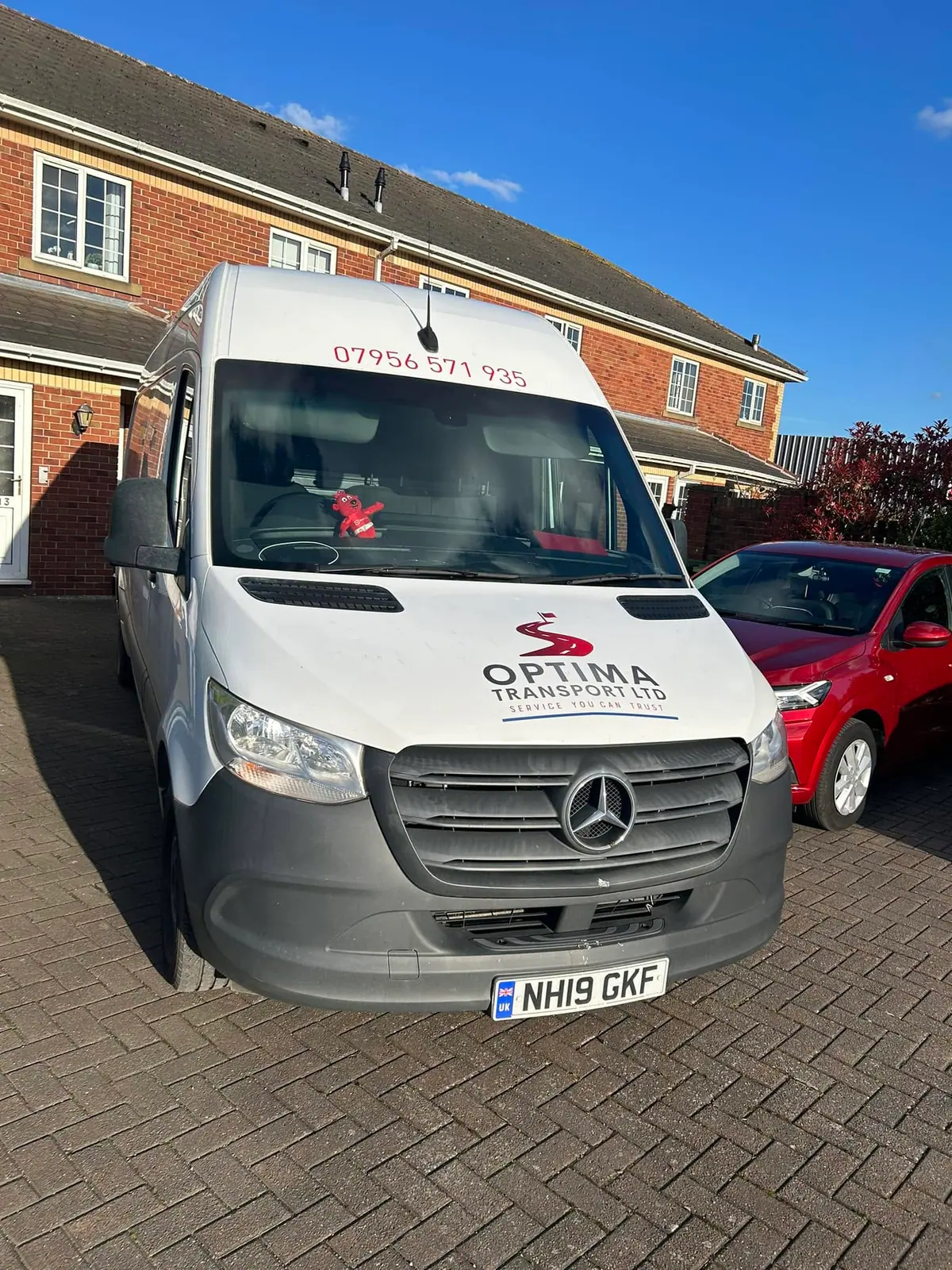 Optima Transport removals van parked outside a brick-built home ready for a Leeds to London house removal