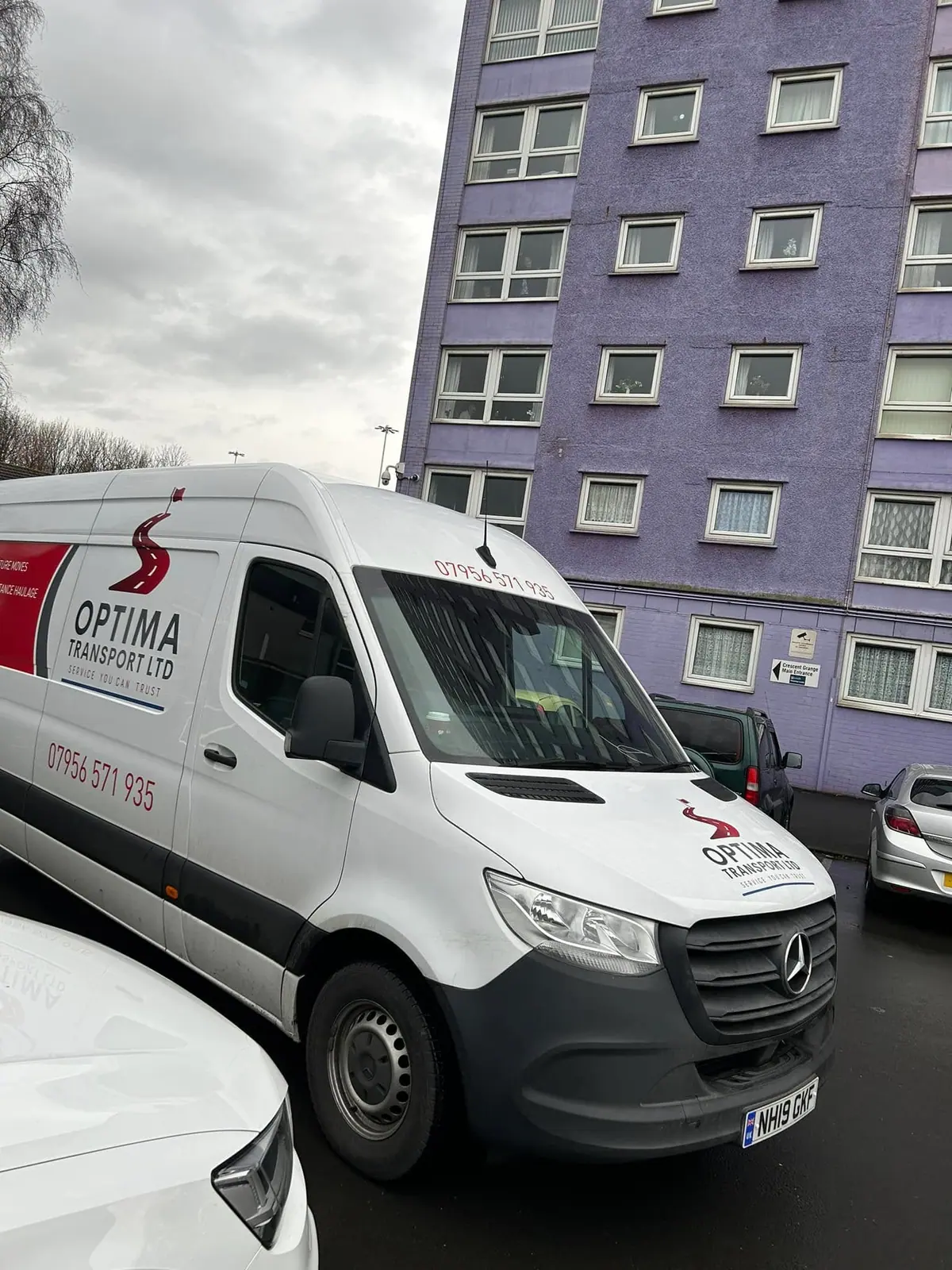 Optima Transport van parked beside a tower block ahead of a long distance removal from Yorkshire