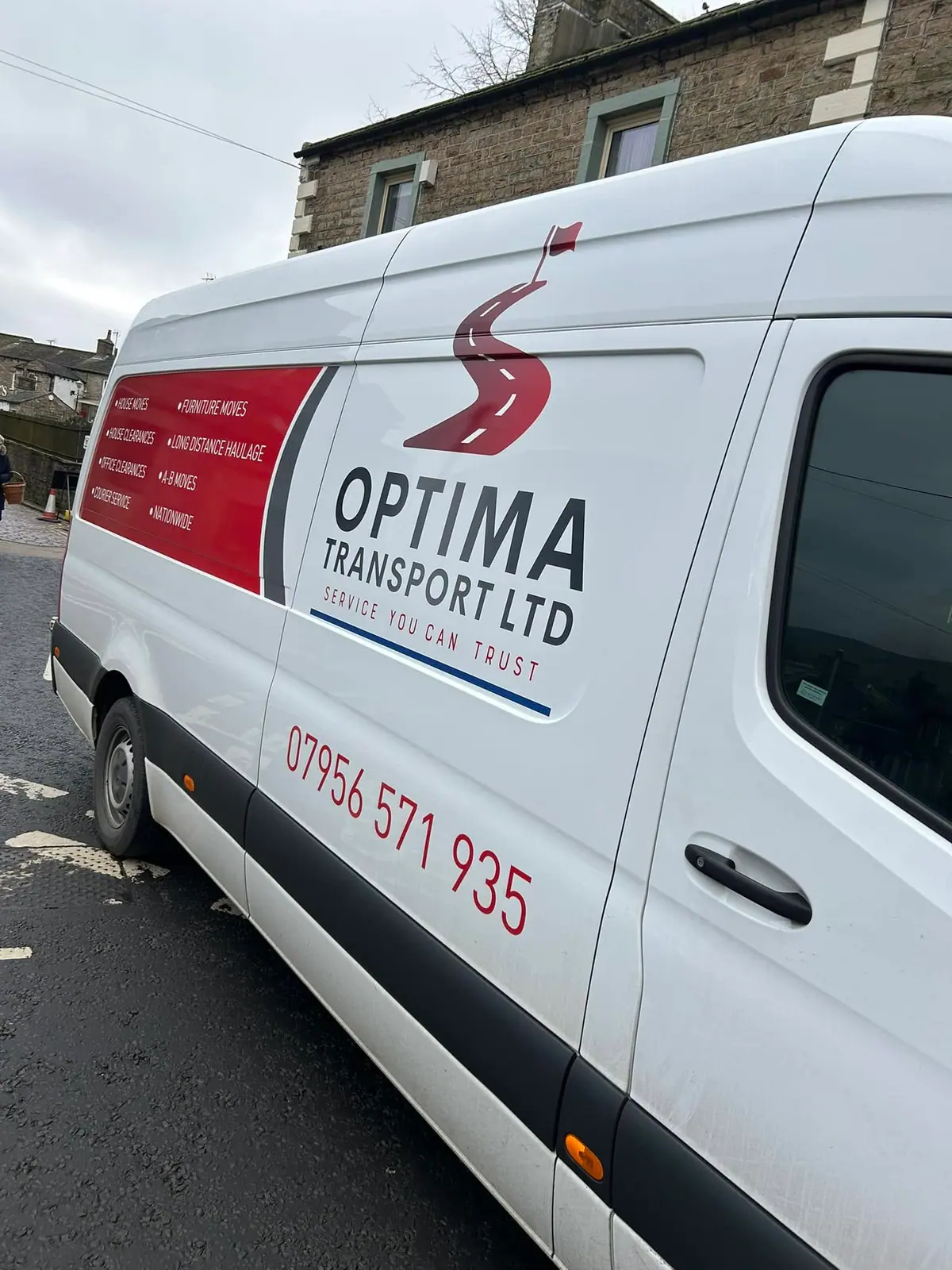 Optima Transport van showing the company logo and its removals, clearances and haulage services