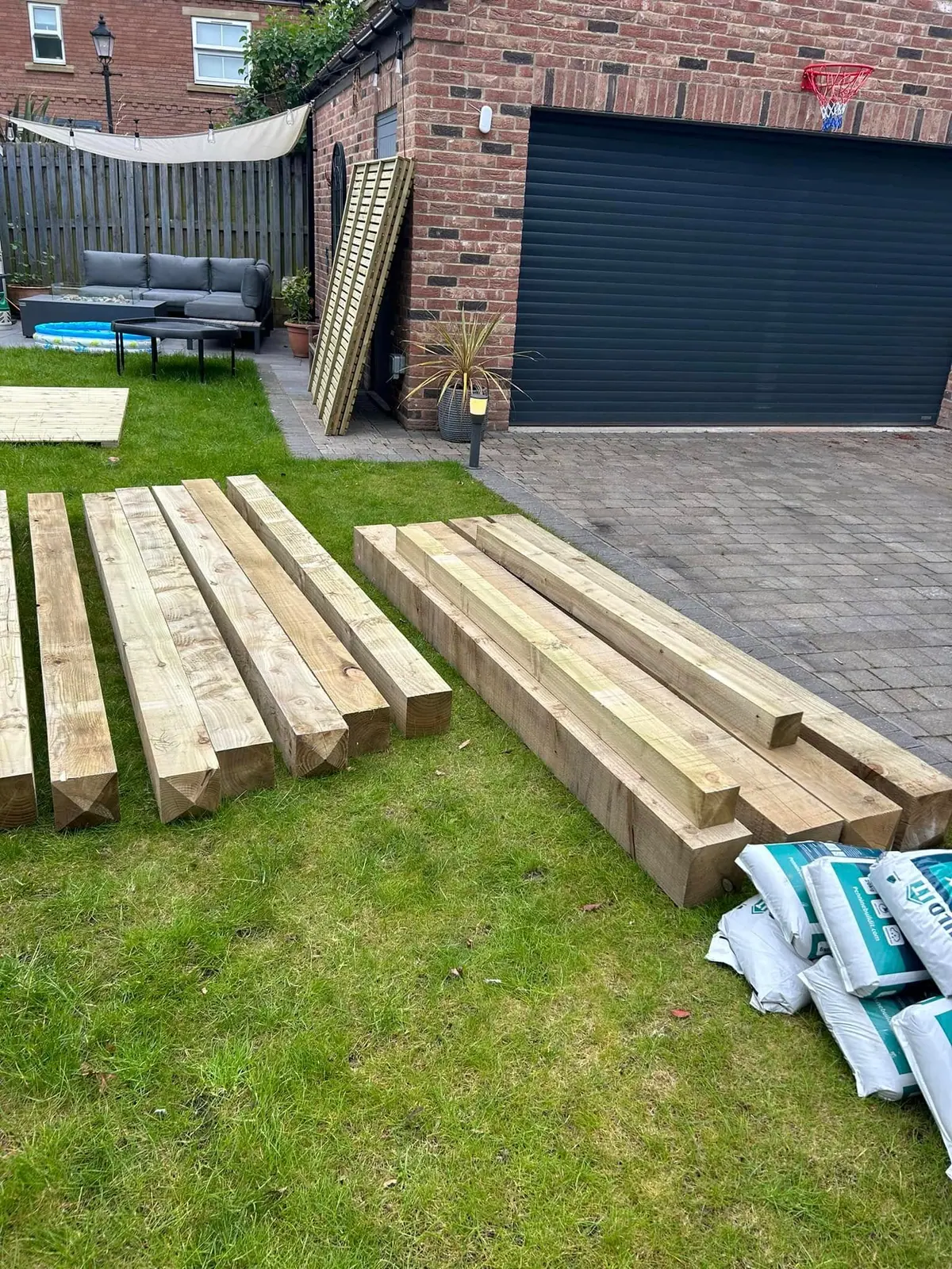 Timber sleepers delivered to a garden by Optima Transport on a short distance haulage job