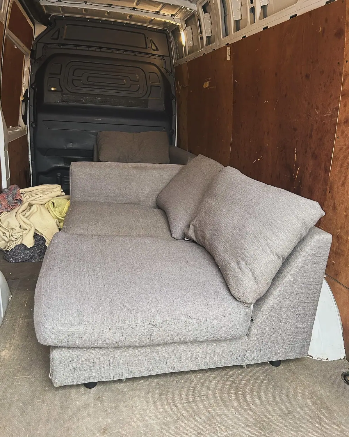 Sofa loaded into an Optima Transport van for single item and furniture transport